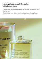 Two bottles of hair care products with text on a light background