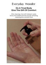 Hand holding a bottle of cleanser with text about comfort and cleansing.