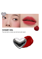 Lipstick with a heart-shaped cap labeled '13 Ruby Veil' on a white background.