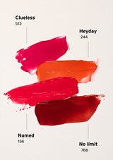 Close-up of a red surface with text about a non-sticky finish and voluminous gloss.
