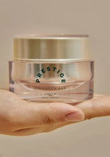 Hand holding a jar of Prestige Collagen Age Cream against a neutral background
