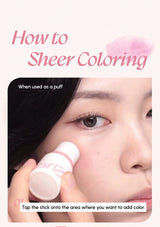 Cosmetic product being used on a person's face with text on sheer coloring.