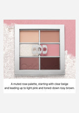 Makeup palette with rose tones on a light pink background