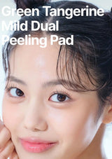 Close-up of a woman's face with text reading 'Green Tangerine Mild Dual Peeling Pad' across the top, showing a skincare product result or packaging context.