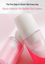 Two pink and white cosmetic bottles labeled 'Mucin Mineral Vita Bubble First Essence' on a soft pink background, with promotional text at the top.