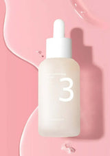 Skincare serum bottle with dropper on a pink background