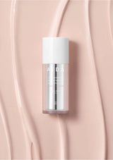 Skincare bottle with 'ALDA' branding on a pink background