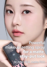 Person holding a makeup-setting spray with text on a neutral background