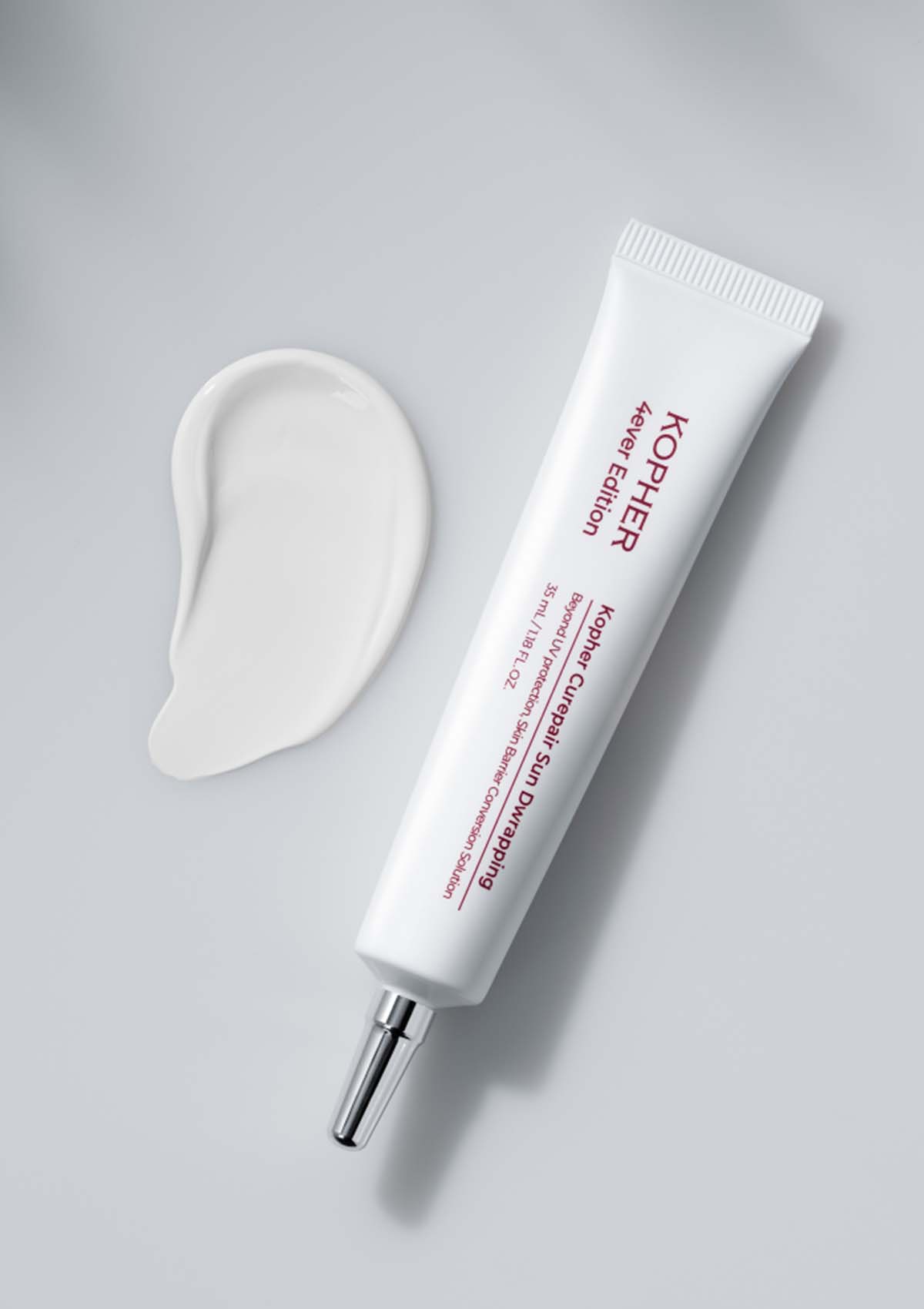 Kiehl's skincare product with applicator on a gray background