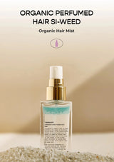 Organic perfumed hair mist bottle with sand in the background