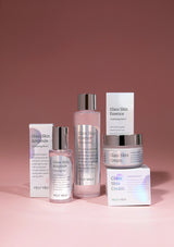 Set of Velvvet skincare products including ampoules, essence, and cream on a pink background