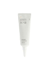 White tube of cream with Korean text on a white background