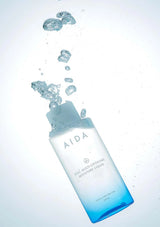AIDA skincare product with water droplets on a light gray background