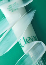 Cosmetic cream with a brush on a green background