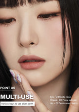 Close-up of a person's face with makeup application details on a dark background