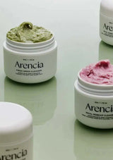 Three jars of Arencia skincare products on a light surface
