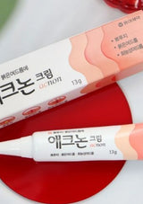 Two tubes of Acne cream with Korean text on a white background
