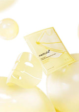 Yellow skincare mask with 'Medicube' branding on a white background
