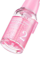 Pink serum bottle with 'numebuzin' branding on a white background