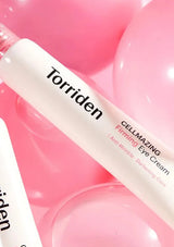 Torriden eye cream bottle on a pink background