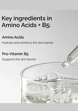 Glass container with dropper and text about amino acids and Pro-Vitamin B5 on a gray background