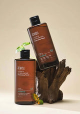 Two bottles of Acwell Licorice pH Balancing Cleansing Toner on a wooden surface with a neutral background.