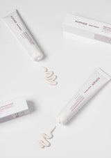Kopher skincare products with cream on a white background