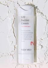L22 Barrier Cream bottle by Vely Vely on a marble background
