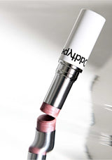 Close-up of a metallic pen with a white cap on a light gray background