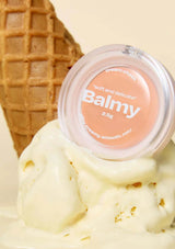 Balmy balm container on top of ice cream with a waffle cone in the background