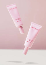 Two pink skincare products with visible branding on a light pink background