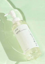 Skincare bottle labeled 'Anhua' on a light green background
