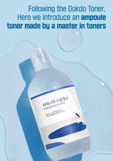 A bottle of toner with a blue label on a light blue background