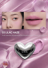 Lipstick with heart-shaped cap and close-up of lips wearing the shade '03 Lilac Haze'.