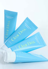 Multiple tubes of 'Clear Dea' product on a light blue background