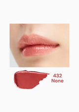 Close-up of lips with a swatch of lipstick labeled '432 None' on a white background