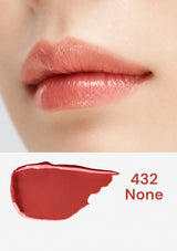 Close-up of lips with a swatch of lipstick labeled '432 None' on a white background