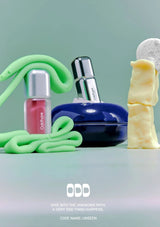 Cosmetic products with a green slime-like substance on a light blue background, featuring the brand 'ODD'.
