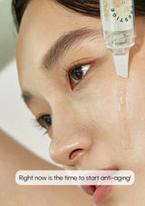 Close-up of a person applying a skincare product to their face with a dropper.