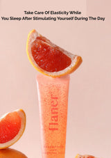 Flaner grapefruit facial scrub with grapefruit slices on a pink background