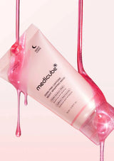 PinkMedicube skincare product with pink liquid dripping from it on a white background