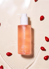 Kophier skincare bottle on a beige background with red berries