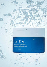 AIDA hyaluronic acid ampoule pad packaging on a blue background with water droplets.