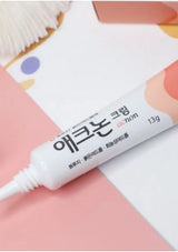 Cosmetic tube labeled 'acnon' on a pink background