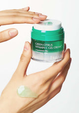 Hand holding a jar of Ellevive Green Citrus Vitamin C Gel Cream with a visible sample on the palm.