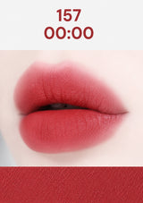 Close-up of a person wearing a red lipstick with a neutral background