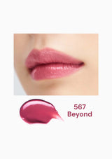 Close-up of pink lipstick on lips with a swatch labeled '567 Beyond' below.