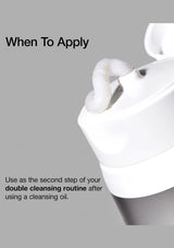 White facial cleansing pad with text on a gray background