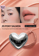 Lipstick with a heart-shaped cap on a white background, featuring a close-up of a person's lips wearing the lipstick.