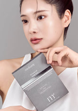 Woman holding a Moryan skincare product box against a gray background